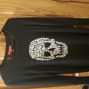 Long sleeve light weight sweater with skull logo from Saks. Gently worn.